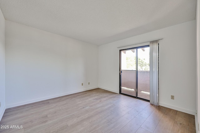 5757 W Eugie Ave Unit 2068, Glendale, AZ 85304 - spare room featuring light wood-style flooring, a textured ceiling, and baseboards