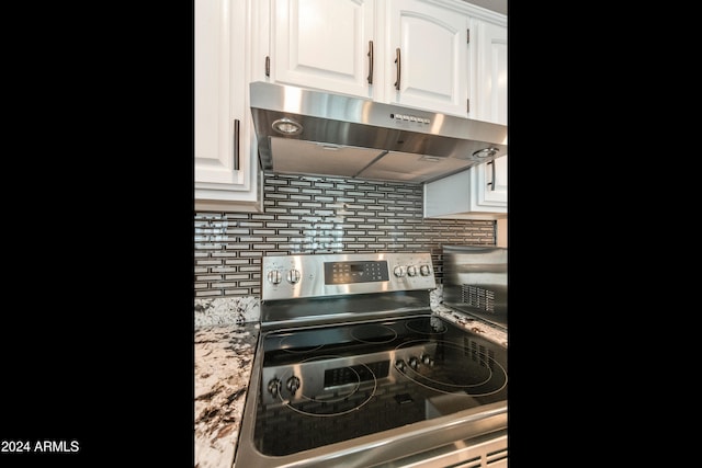 kitchen with stainless steel electric range, white cabinetry, ventilation hood, and backsplash