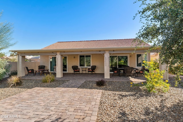 back of property featuring a patio