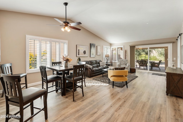 dining area with high vaulted ceiling, light hardwood / wood-style floors, and ceiling fan