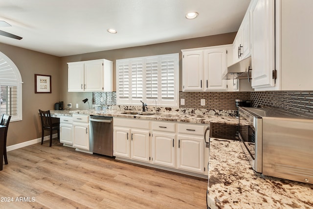 kitchen with white cabinetry, stainless steel appliances, sink, and light hardwood / wood-style flooring