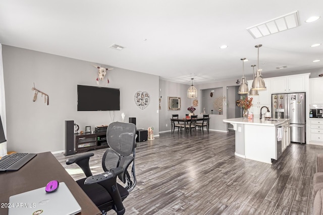 home office featuring dark hardwood / wood-style floors and sink