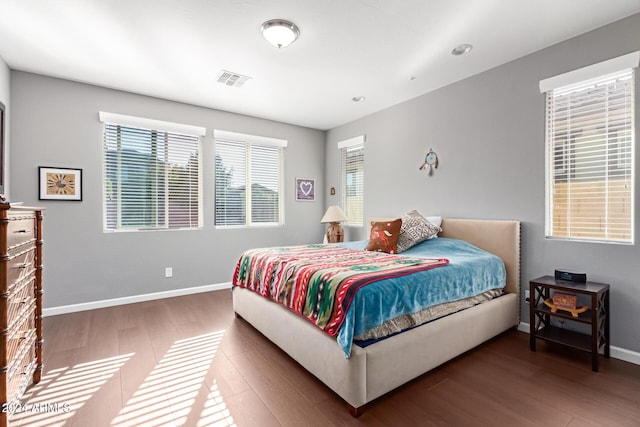 bedroom with dark hardwood / wood-style floors