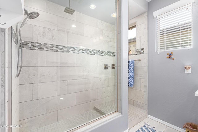 bathroom featuring a tile shower and tile patterned flooring