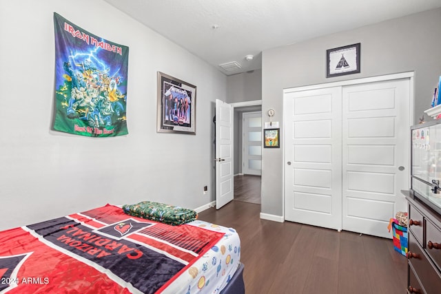 bedroom featuring dark hardwood / wood-style floors and a closet