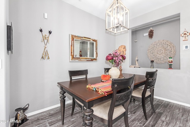 dining area with an inviting chandelier and dark hardwood / wood-style flooring