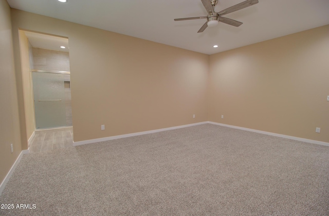 unfurnished room with light colored carpet and ceiling fan