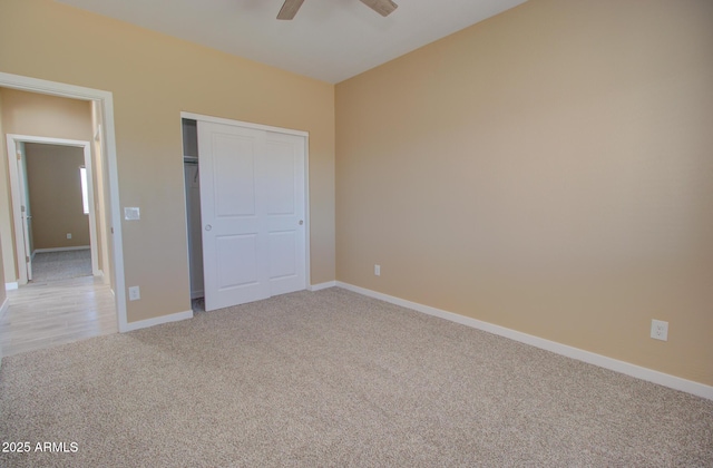 unfurnished bedroom featuring light carpet, a closet, and ceiling fan