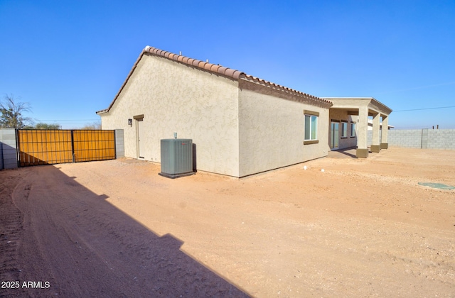 back of house featuring central AC