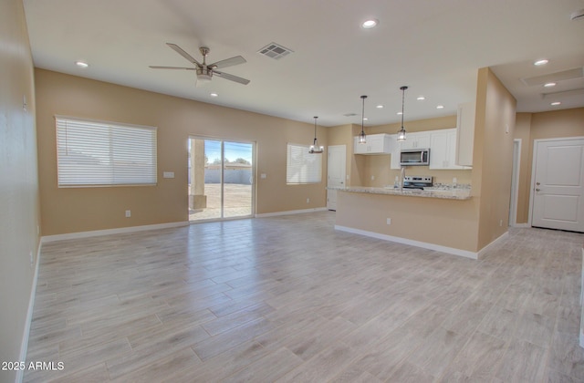 unfurnished living room featuring ceiling fan