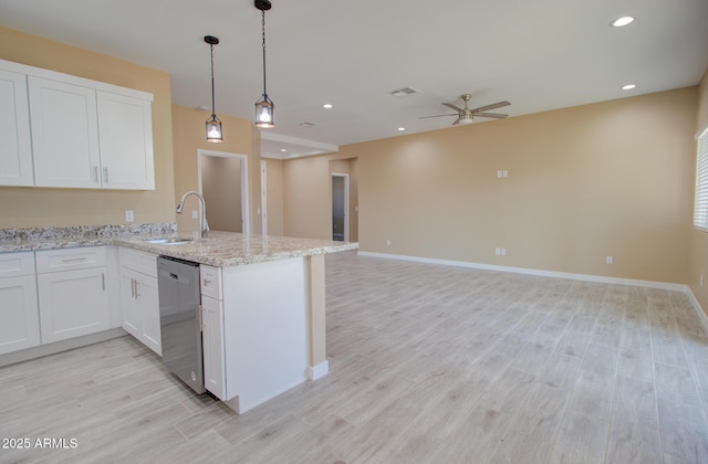 kitchen featuring sink, light stone countertops, white cabinets, stainless steel dishwasher, and kitchen peninsula