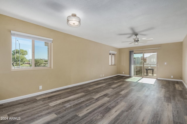 unfurnished room with a textured ceiling, dark hardwood / wood-style flooring, and ceiling fan