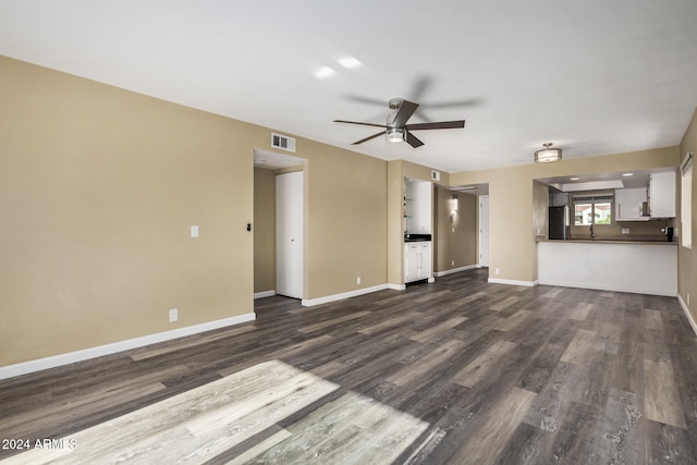 unfurnished living room with ceiling fan, dark hardwood / wood-style flooring, and sink