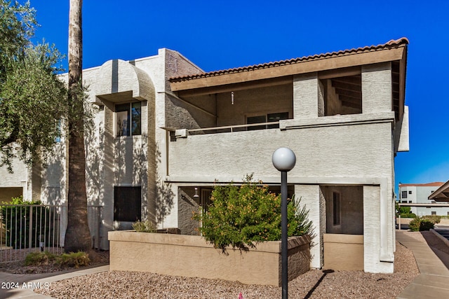 view of front of house with a balcony