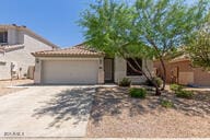 16813 S 30th Ave, Phoenix, AZ 85045 - view of front of house featuring driveway and an attached garage