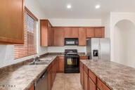 16813 S 30th Ave, Phoenix, AZ 85045 - kitchen with black appliances, brown cabinets, a sink, recessed lighting, and arched walkways