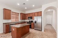 16813 S 30th Ave, Phoenix, AZ 85045 - kitchen featuring appliances with stainless steel finishes, a center island, brown cabinets, and recessed lighting