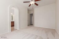 16813 S 30th Ave, Phoenix, AZ 85045 - carpeted spare room featuring ceiling fan, arched walkways, and baseboards