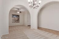 16813 S 30th Ave, Phoenix, AZ 85045 - unfurnished dining area featuring arched walkways and a chandelier