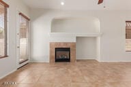 16813 S 30th Ave, Phoenix, AZ 85045 - unfurnished living room with a fireplace, a ceiling fan, recessed lighting, and tile patterned flooring