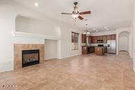 16813 S 30th Ave, Phoenix, AZ 85045 - unfurnished living room featuring ceiling fan, a glass covered fireplace, baseboards, recessed lighting, and arched walkways