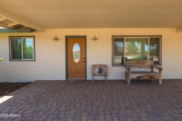 doorway to property with brick siding