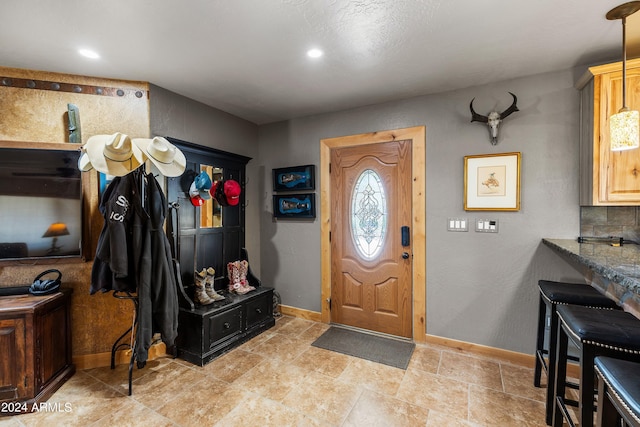 entrance foyer featuring recessed lighting and baseboards