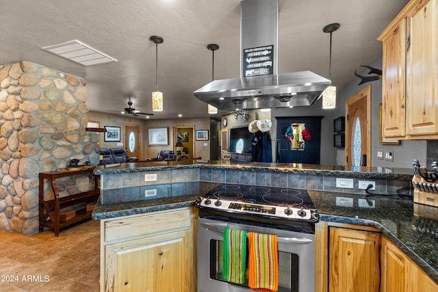 kitchen featuring dark stone countertops, stainless steel electric range, decorative light fixtures, ceiling fan, and island exhaust hood