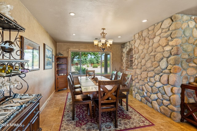 dining room featuring a notable chandelier and a textured ceiling