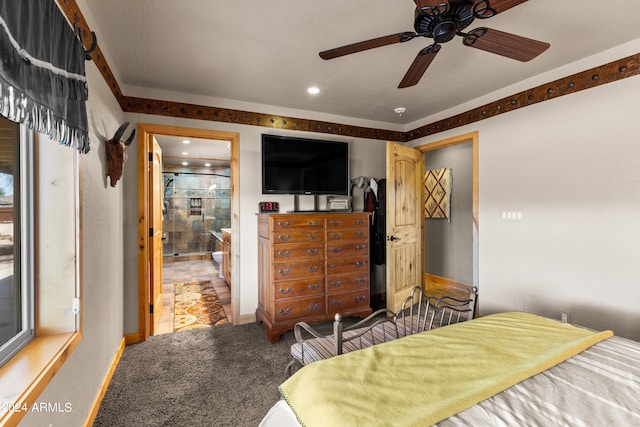 carpeted bedroom featuring ceiling fan and ensuite bathroom