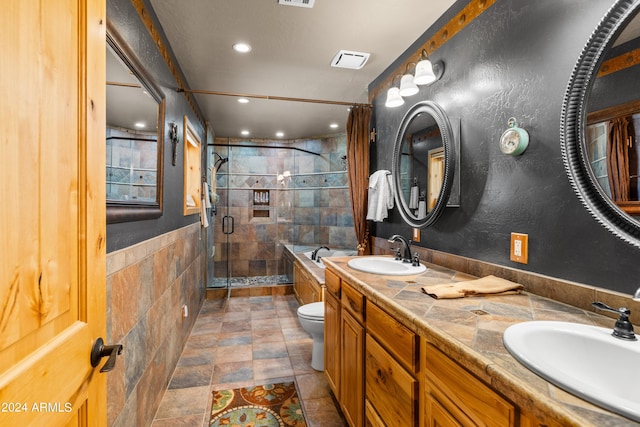 full bathroom with vanity, toilet, tile walls, and plus walk in shower