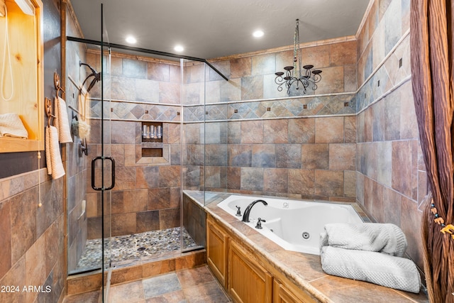 bathroom with tile walls and shower with separate bathtub