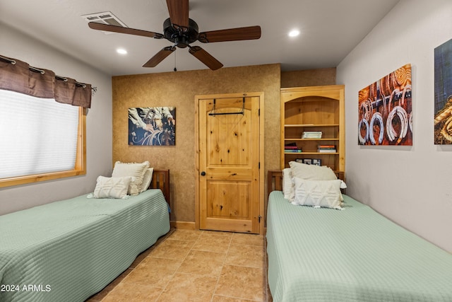 tiled bedroom featuring ceiling fan