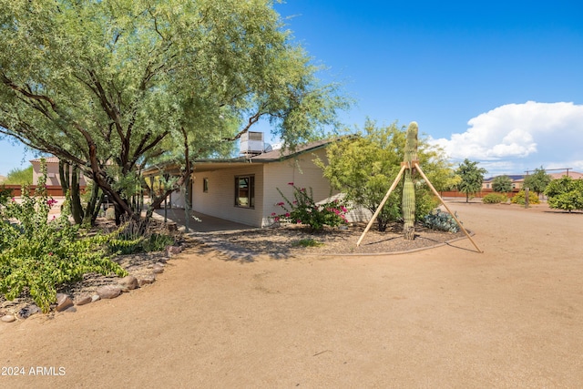 view of front of house with a patio and a chimney