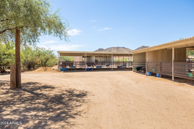 exterior space with an exterior structure, a mountain view, and an outdoor structure