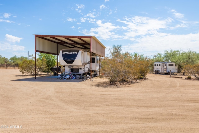 view of parking / parking lot featuring a detached carport and driveway