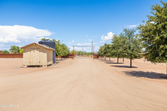 exterior space featuring a gated entry and dirt driveway