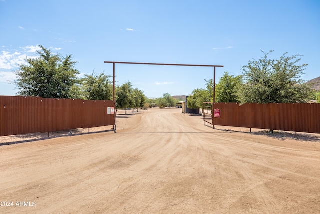 view of street featuring a gated entry, driveway, and a gate