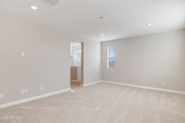 empty room featuring recessed lighting, visible vents, light carpet, and baseboards