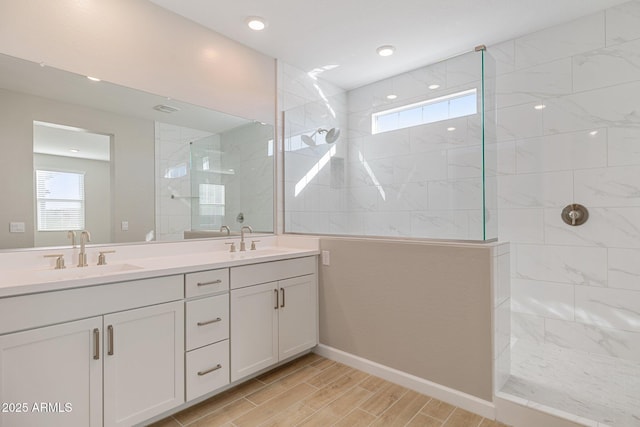 bathroom with wood finish floors, a sink, and walk in shower