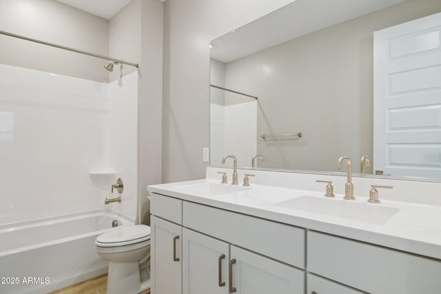 bathroom featuring double vanity, shower / bath combination, a sink, and toilet