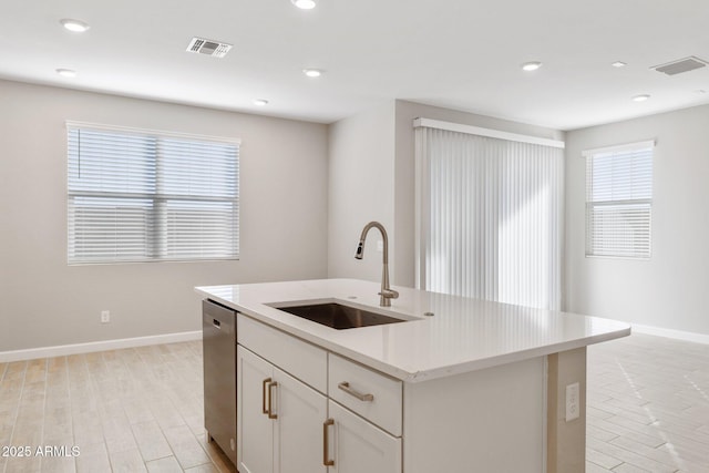 kitchen with dishwasher, light wood-type flooring, a sink, and visible vents