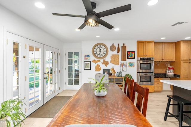 dining room with french doors, light wood-style flooring, recessed lighting, a ceiling fan, and visible vents