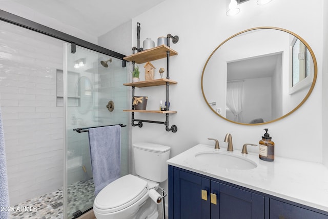 bathroom featuring vanity, a stall shower, and toilet
