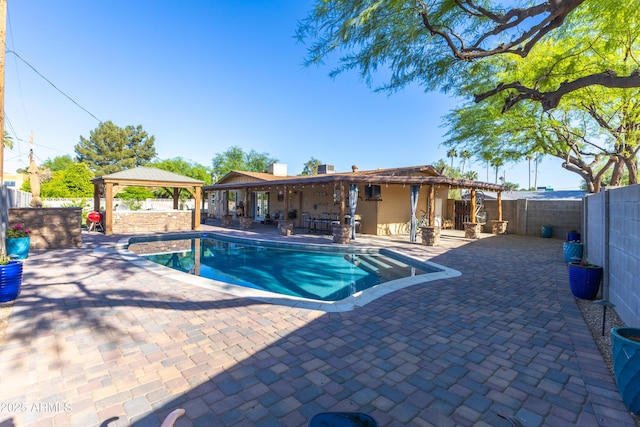 view of swimming pool with a gazebo, a fenced backyard, a fenced in pool, and a patio