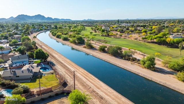 birds eye view of property featuring a water and mountain view, view of golf course, and a residential view