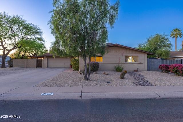 single story home with fence, an attached garage, and driveway