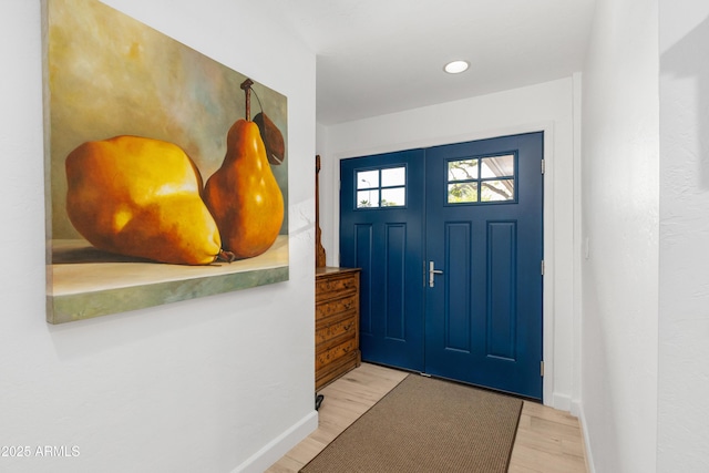 entryway with light wood-style floors, baseboards, and recessed lighting