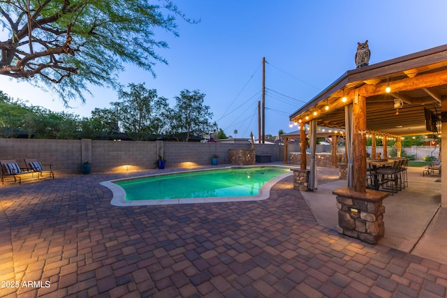 view of pool with a patio, a fenced backyard, a fenced in pool, and a gazebo