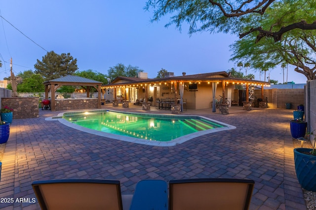 view of pool featuring a fenced backyard, a patio, and a gazebo
